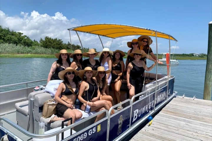 a group of people in a small boat in a body of water